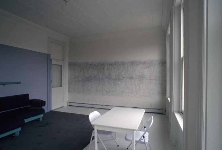 slide IRC.2012.00084 showing Allan Wexler's permanent installation, Bed-Sitting Room for Artist in Residence [left], and William Anastasi's permanent installation, April 15 1989, 32 Minutes, 4B [right] at the Mattress Factory, 1989.