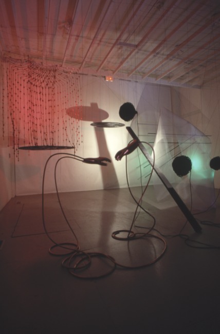 slide IRC.2012.02073 (old number: TIE.H-D006) showing Hanne Tierney's performance, Drama for Strings in Three Movements: Light, Sound, Gesture, at the Mattress Factory, 1988.