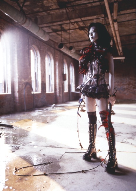 slide IRC.2012.01627 (old number: IUM.X-T003) showing a still from ium's filmed and screened performance, Tales from the Warehouse, at the Mattress Factory, 1999.