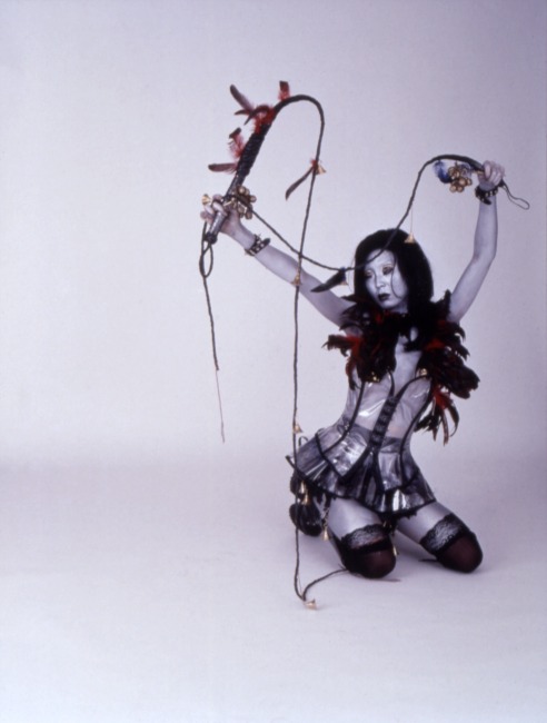 slide IRC.2012.01634 (old number: IUM.X-T010) showing a still from ium's filmed and screened performance, Tales from the Warehouse, at the Mattress Factory, 1999.