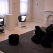 Digital image IRC.2013.00881 showing John Smith's video performance of David Sedaris's play, A Walk through Destiny's Plaything, at the Mattress Factory, 2002.