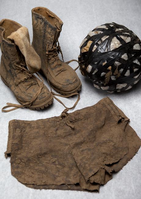 Mud boots, mud ball, and mud shorts from Kim Jone's "Mudman" Performance, 1990
