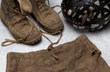 Mud boots, mud ball, and mud shorts from Kim Jone's "Mudman" Performance, 1990