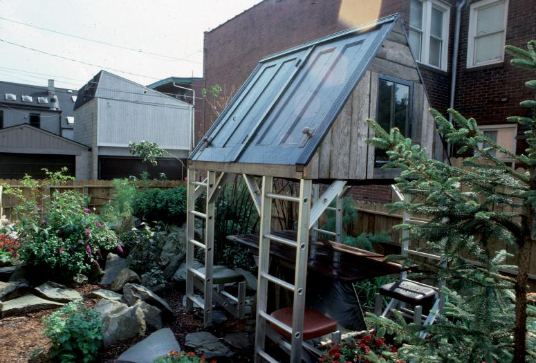 slide IRC.2012.00067 (old number: ACC.V-M004) showing Vito Acconci's garden installation, Making Shelter: House of Used Parts, at the Mattress Factory, 1986.