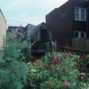 slide IRC.2012.00064 (old number: ACC.V-M001) showing Vito Acconci's garden installation, Making Shelter: House of Used Parts, at the Mattress Factory, 1986.