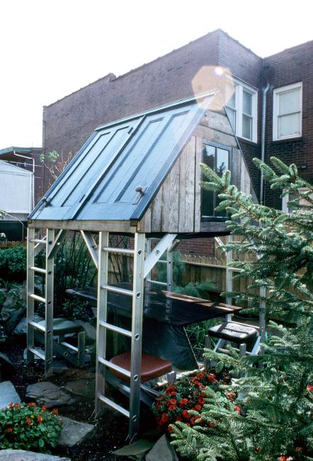 slide IRC.2012.00066 (old number: ACC.V-M003) showing Vito Acconci's garden installation, Making Shelter: House of Used Parts, at the Mattress Factory, 1986.