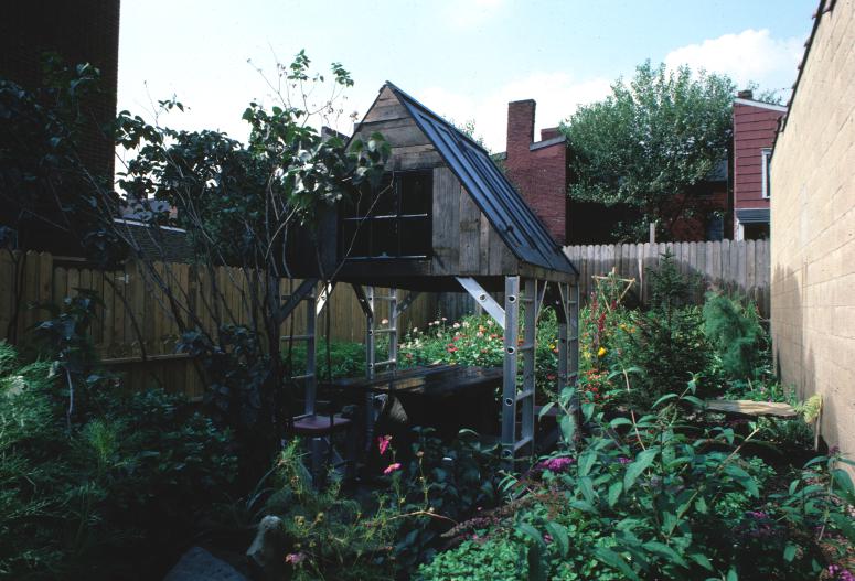 slide IRC.2012.00070 (old number: ACC.V-M007) showing Vito Acconci's garden installation, Making Shelter: House of Used Parts, at the Mattress Factory, 1986.