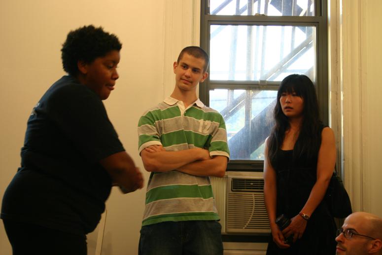 Digital image IRC.2013.03648 showing Vanessa German's performance, Random Black Girl, in front of her installation, Fantastic, at the Mattress Factory, 2005.