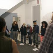 Digital image IRC.2013.03110 showing Toi Derricotte's performance, Landscape of the Body - Poems, Allan Wexler's permanent installation, Bed-Sitting Room for Artist in Residence [left], and William Anastasi's permanent installation, Untitled (Calisthenic Series) [right], at the Mattress Factory, 2005.